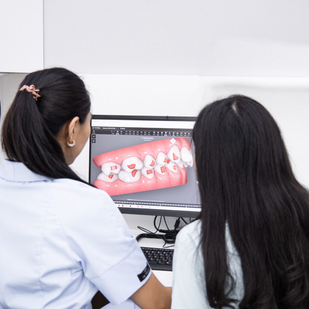 Dental professionals reviewing digital images to evaluate bite function and oral health.